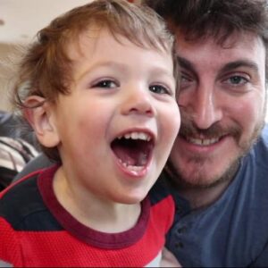 Man laughing with his son